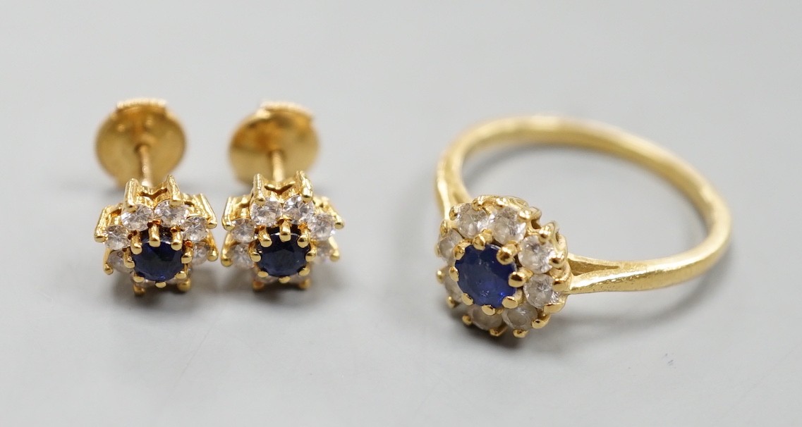 A modern 18ct gold, sapphire and diamond set circular cluster ring, size L and a pair of matching earrings, gross weight 4.6 grams.